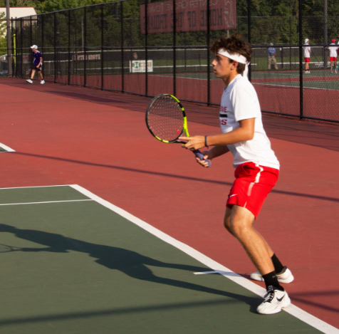 Senior Mason Runkle prepares to receive a serve.