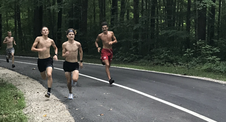 Senior Nick Wilson and freshman Ty Garrett near the top of the hill during the second workout at the cross country teams Spring Mill camp.