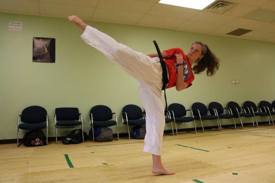 Sophomore+Emma+Bohanon+practices+a+kick+during+karate+training.