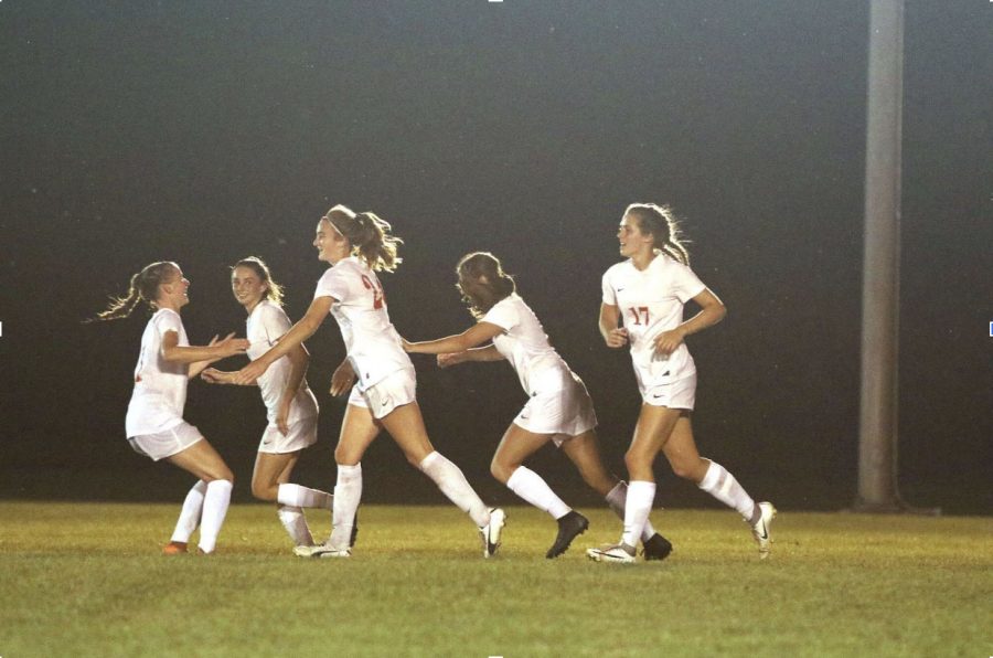 The girls soccer team celebrates during their game against Pike.