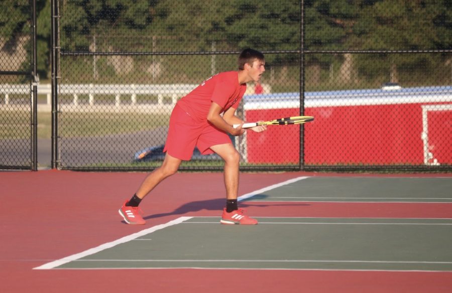Junior Carson Contos looks to return a shot against his opponent. 