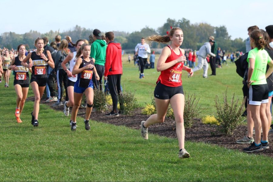 Senior Bella Hodges runs during semistate at Blue River Cross Country course.