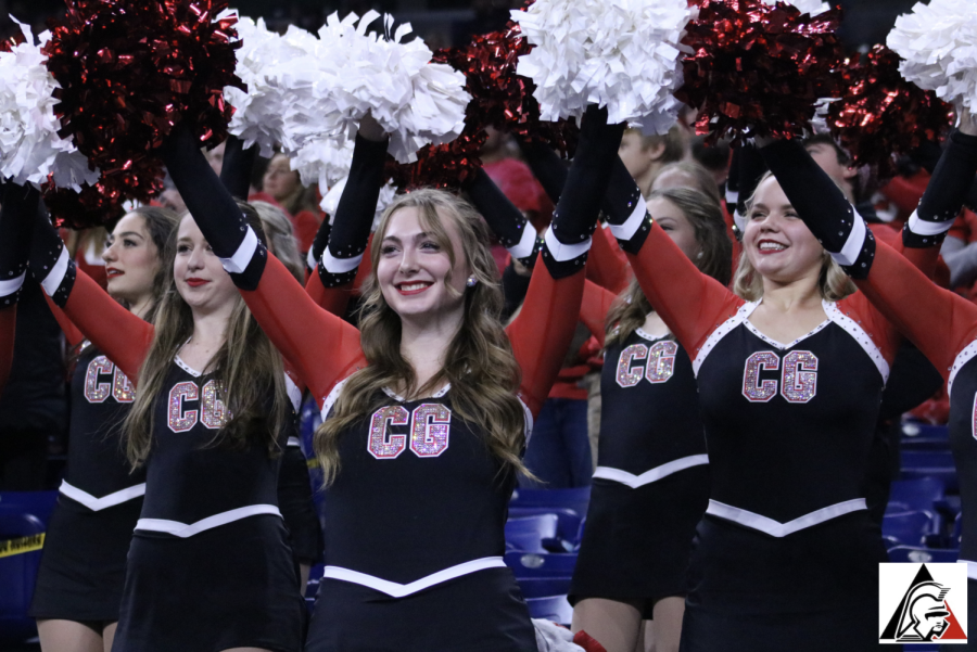 Lindsey Held, senior captain, leads the varsity dance team in cheering on the defense at the end of the second quarter.