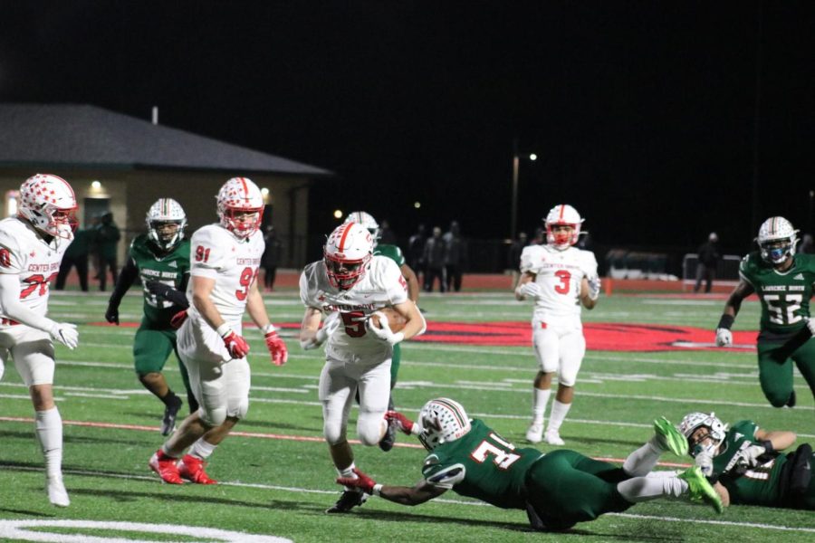 Drew Wheat dodges a Lawerence North defender in Center Grove’s 29-19 regional championship victory. Wheat had 38 rushing yards and a touchdown to go along with his 32-yard punt return for a touchdown. 
