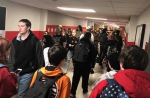 Students walk through a crowded hallway during passing period.