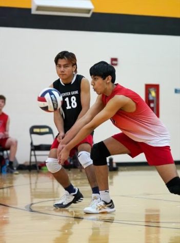 Kevin Panchal dives for the ball during a volleyball match.