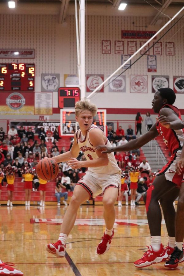 Junior Marcus Ankney drives the ball against a Pike defender in the Trojans Dec. 10 54-66 loss.