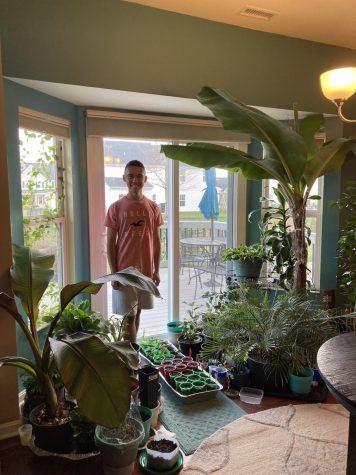 Christian Encarnado stands with his plants. 