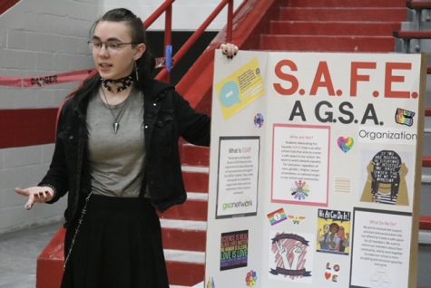 A student promotes the GSA SAFE club at the Club Fair in the West Gym on Monday.