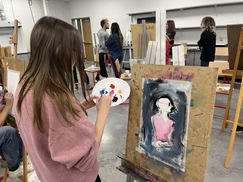 Senior Hannah Ellinger paints during the AP Studio Art period 9 paint battle on Thursday.