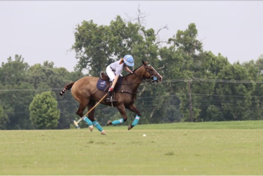 Sophomore Zoë Carpenter swings her mallet while riding her horse during a polo practice. Photo contributed 