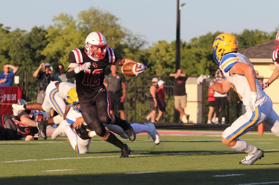Micah Coyle evades a Carmel defender in the first half of last Friday’s Copper Kettle game.