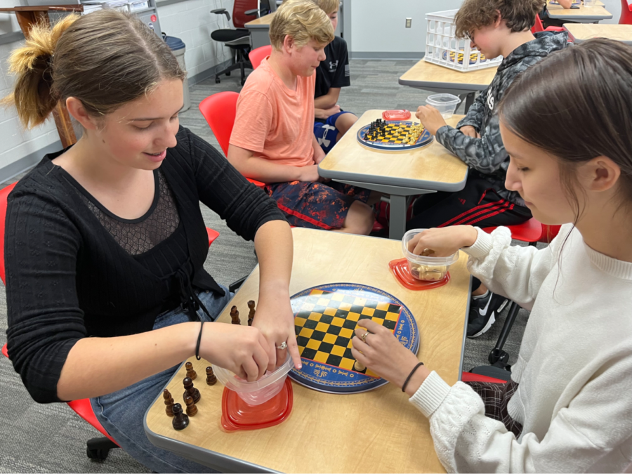During a recent Chess Club meeting, sophomore Lillian Horner competes at chess against junior Isabella Dills. “I think the purpose is to encourage students to think critically and strategize in an interesting way,” Dills said. Chess Club teaches students to use critical thinking while having fun with their friends.
