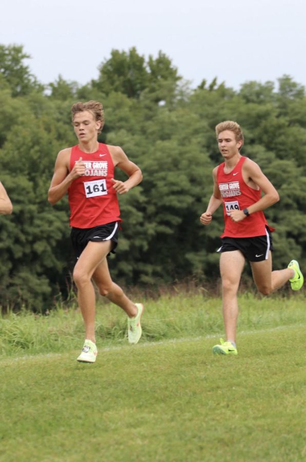 Seniors Jarret Rockwell and Levi Farmer run through the Terre Haute cross country course. The team finished third in the competition, qualifying them for the state meet.