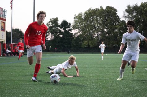 Junior winger Ely Detty dribbles by a falling Lebanon defender during the team’s 7-0 win on Sept. 29.