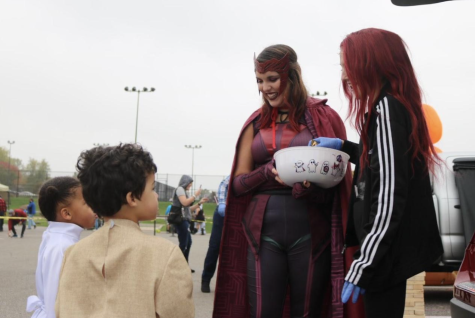 In costume, senior Brinna Porat hands out candy to trick-or-treaters at last years Robotics Trunk or Treat event.