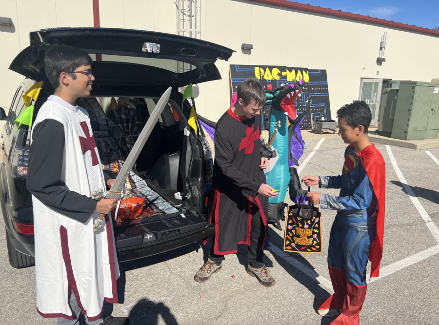 Senior+Mitul+Patel+and+junior+Brodyn+Pyra+pass+out+candy+from+their+medieval+trunk+during+Saturdays+trunk-or-treat+event.