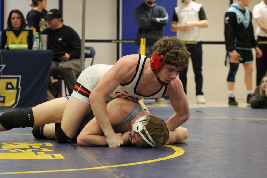 Then-freshman Silas Stits rides out his opponent during the  2021-22 regionals.