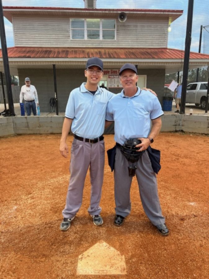 Senior Eli Gillard poses with his father, who is also an umpire, while officiating. Photo contributed