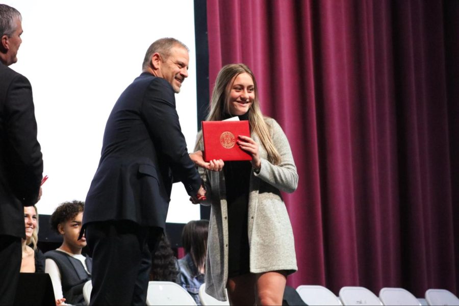 Smiling, senior Mackenzie Hausdorfer shakes hands with Superintendent Rich Arkanoff while posing for a photo and accepting her SYCGA diploma. Once a month on Thursdays, SYCGA attendees participated in learning opportunities with community members. This included CPR training with Craig Zollars of the White River Fire Department and a Veteran’s Day event.