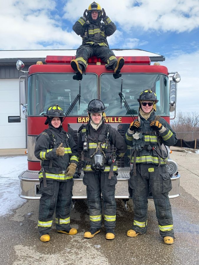 Junior Aiden Murray (center) poses in front of a Bargersville Fire Department truck with C9 peer Austin Ney (left) and fellow-Center Grove students junior Christian Durbin (right) and junior Colin Sissons (top).