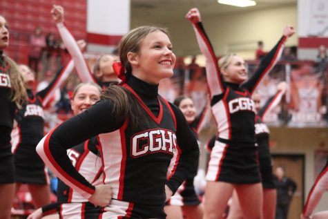 Junior Whitney Stephen smiles at the cheer teams halftime performance on Jan. 28.