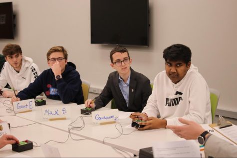 Seniors Jacob Thornton, Grant Embrey, Max Barton and Gowthamm Mandala hold buzzers at a Quiz Bowl competition in December.