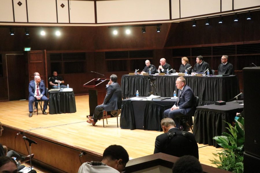 Indiana Supreme Court justices and attorneys for the plaintiff and Ball State sit on stage in UIndys Performance Hall.