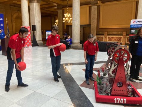 Senior Mitul Patel, senior Jacob Thornton and sophomore Natalie Holverson demo one of their robots at the Indiana State House.