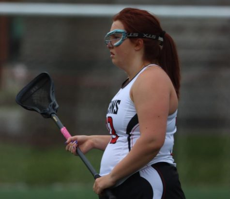 Madison Harrigan stands with her lacrosse stick during the girls lacrosse teams senior night on May 2.