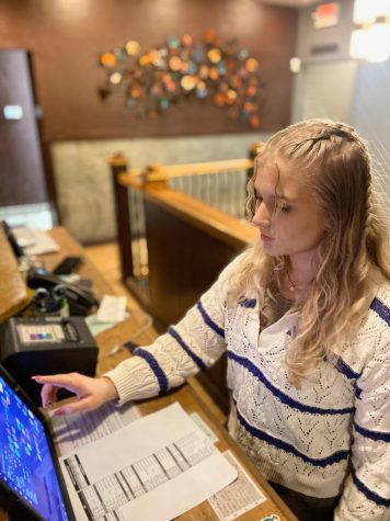 Senior Madeline Sprouse works behind the front desk at Stone Creek Dining.