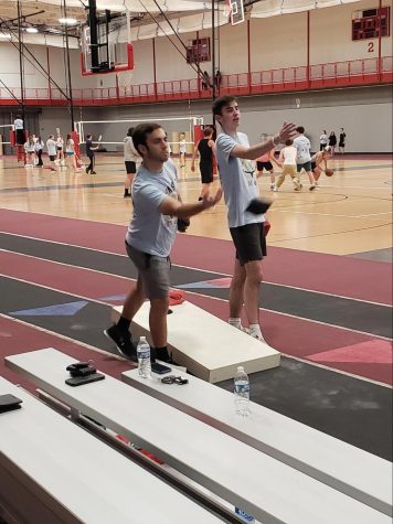 Seniors Ethan Stout and Will Fosnot play cornhole at the Midnight Mile on Friday.