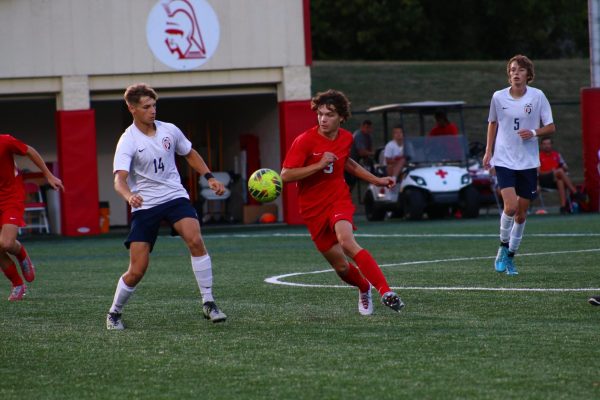 Junior Landon Gilstorf dribbles with the ball in the midfield during the Trojans 4-0 home win against Plainfield on September 19, 2023.