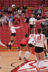 Senior Sophia Sabol jumps to meet the ball in the volleyball teams home match against Avon. The Trojans would win the match 3-1. 