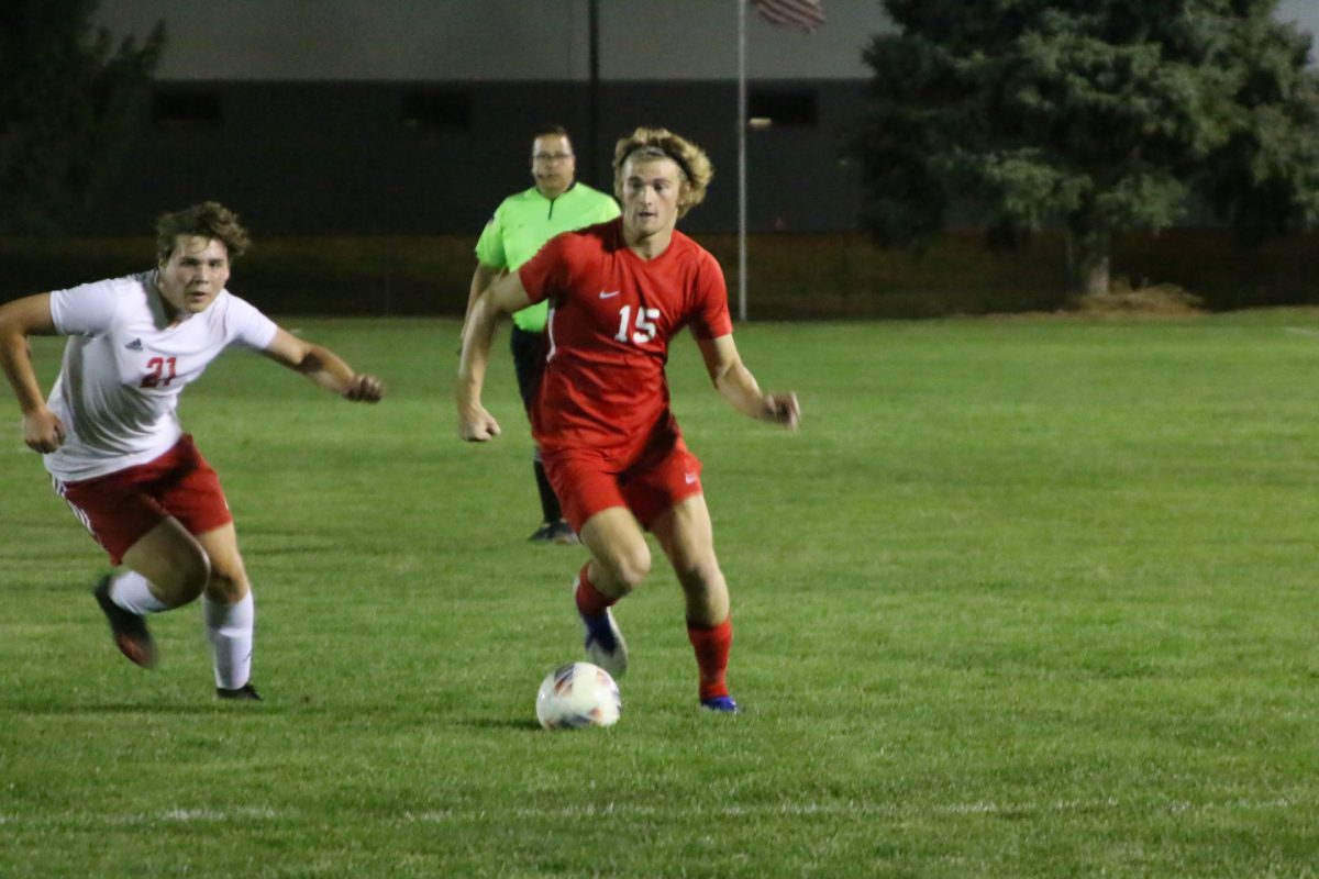 Senior Ely Detty dribbles past a Terre Haute South defender in their sectional semi-final matchup. The following week, Detty would score a decisive last-minute goal to win 1-0 against Bloomington South, and send the Trojans to the regional semi-finals.