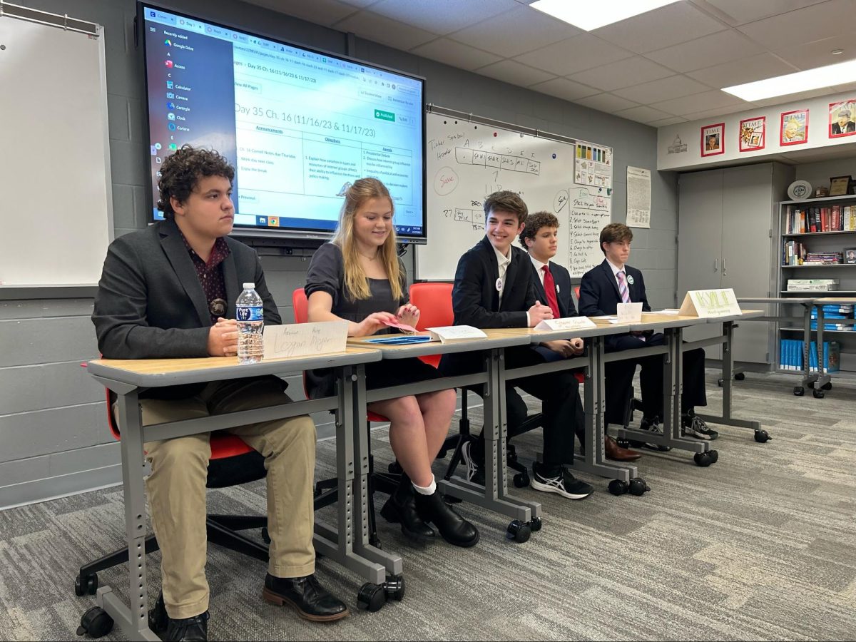 Seniors Logan Meyer, Gabby Rogers, Steiner Goode, Max Williams and Kyle Montgomery sit on a presidential debate panel during their Period 7 AP U.S. Government class.