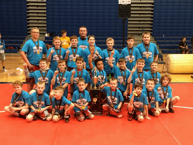 The+Center+Grove+elementary+school+wrestling+team+from+2017+poses+in+front+of+a+trophy+following+the+state+finals.+A+majority+of+this+state-winning+elementary+school+wrestling+team+went+on+to+wrestle+together%2C+such+as+senior+Charlie+LaRocca+and+junior+Silas+Stits.