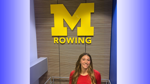 Ava Mardis poses inside the University of Michigan rowing facility during a visit to campus. 