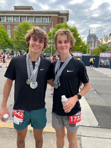 Baylor Winkelmann (right) and Cameron Cox (left) pose after completing their half-marathon.