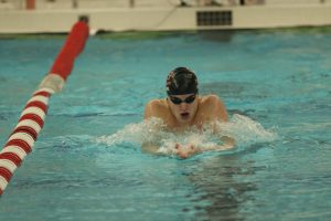 Junior Issac Lewis swims the breaststroke portion of the IM during a varsity meet against Franklin. 