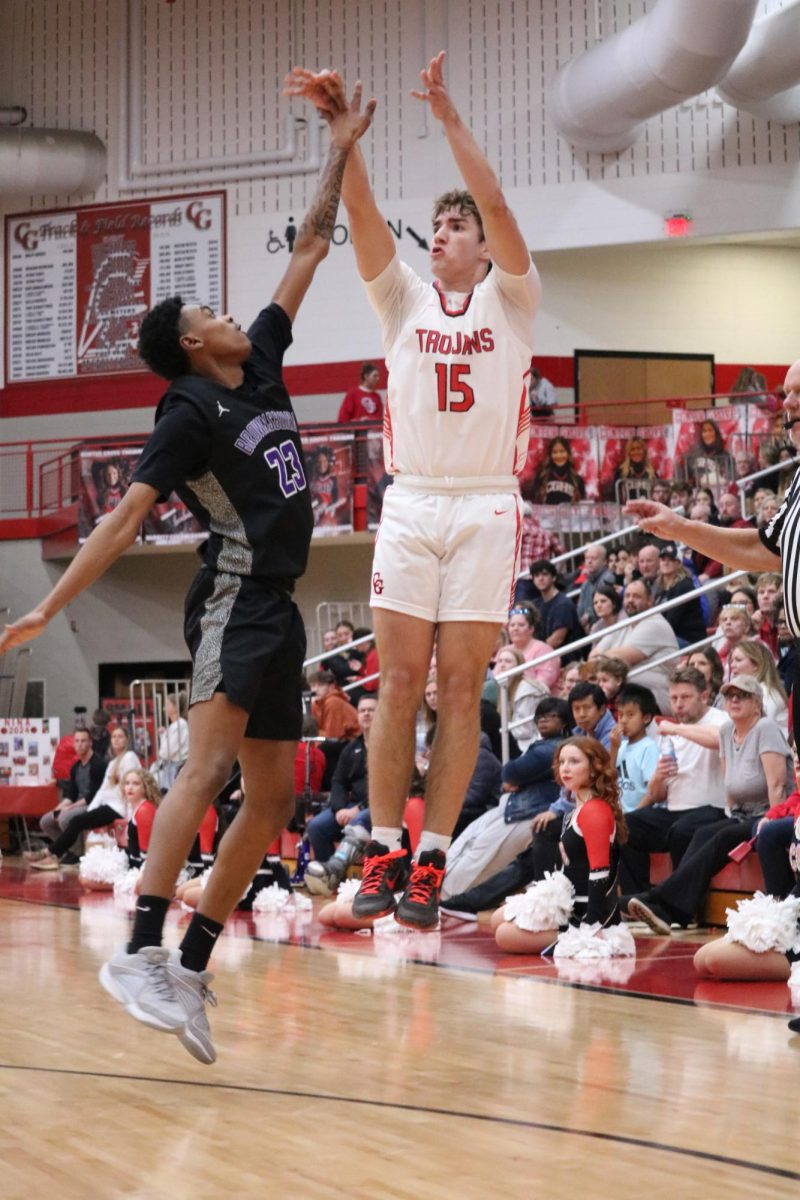 Senior Joey Schmitz fires from the three-point line in the Trojans regular season game against Brownsburg. The Trojans would just etch out the Bulldogs, winning 57-56. 