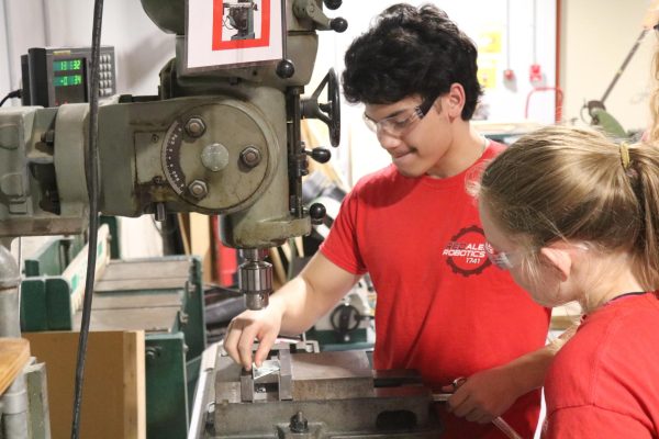 Junior Nick Nutley and freshman Kaylee Holverson mill an aluminum bracket during a robotics meeting. The mill is one of many machines that were able to have their own designated space in the new expansion.
