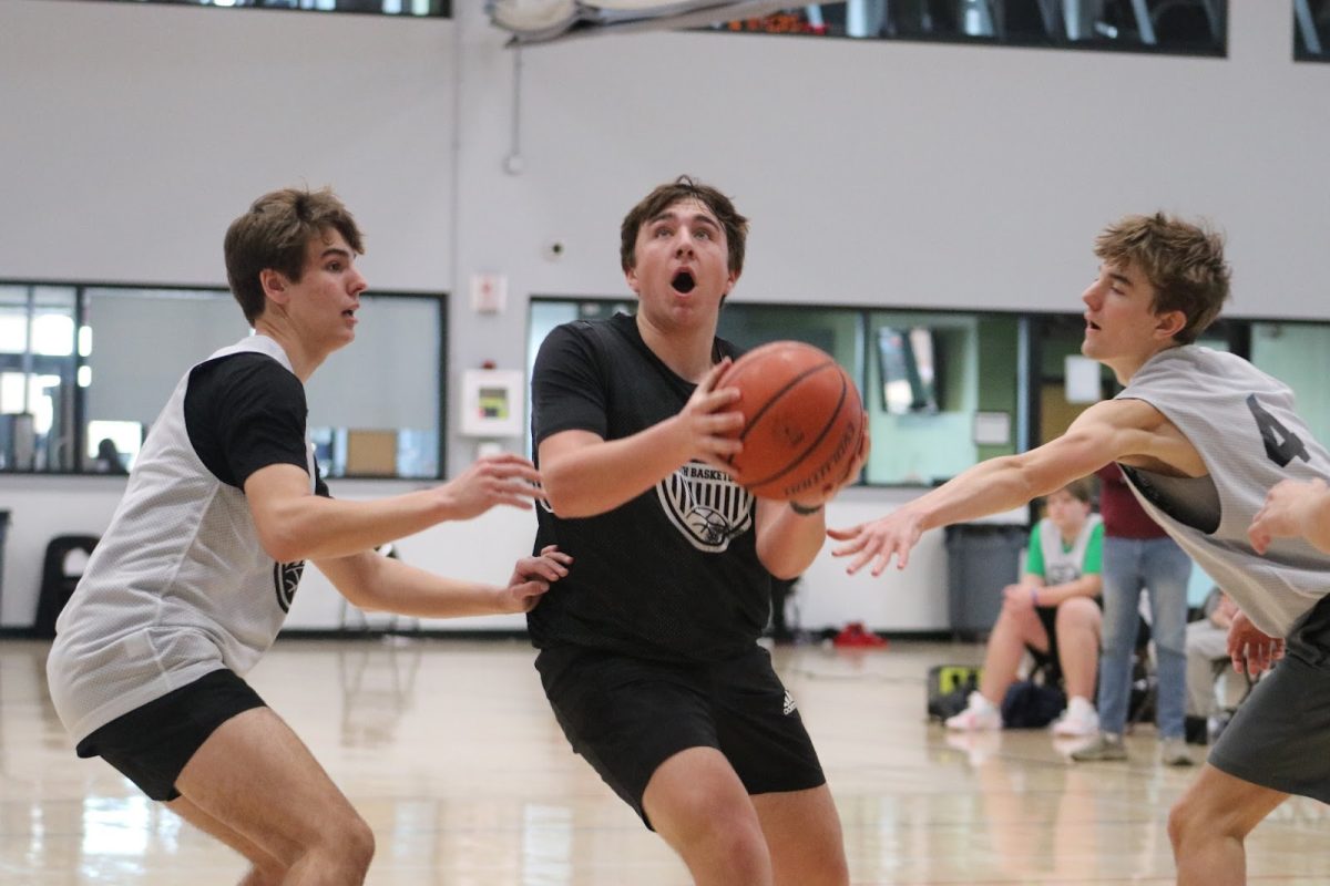Senior Carson Poe breaks through a double team on his path to the basket. “ “I feel CLC basketball is a really fun and competitive environment,” Poe said. “We are trying to have fun but also want to do your best because you want to play well for your team and the cheering crowd.”