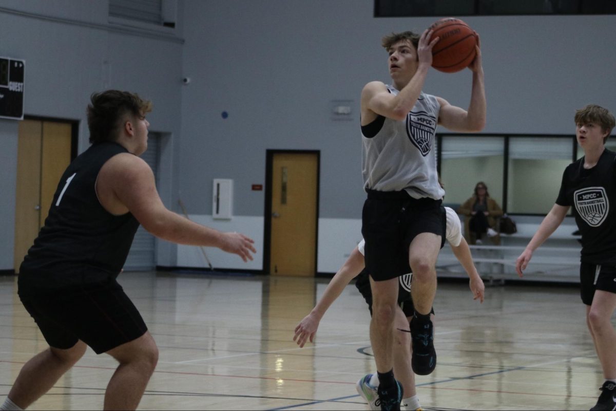 Sophomore Collin Sookram takes a layup under pressure form the defender.“The CLC is an great way to stay active and conditioned and is a physical way to have fun with your friends,” Sookram said.
