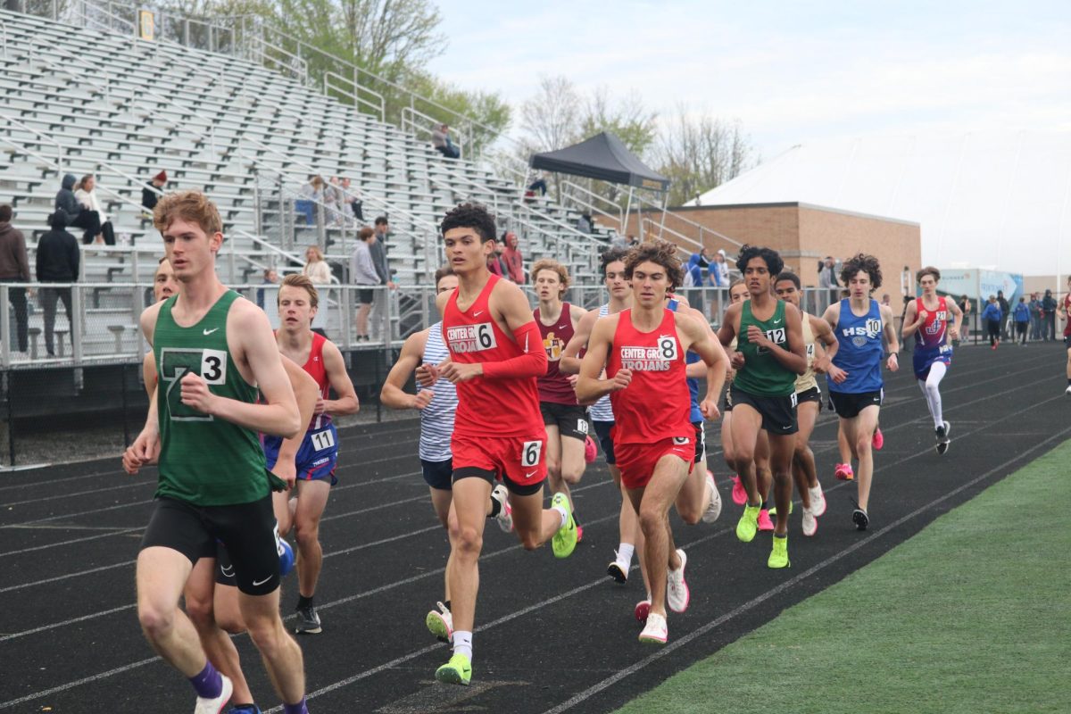 Junior Mason Vrshek sticks with the front pack of the 1600m run on the home stretch of the Dennis McNulty Invitational. Vrshek would later pass the pack in his eventual first place finish in the event.