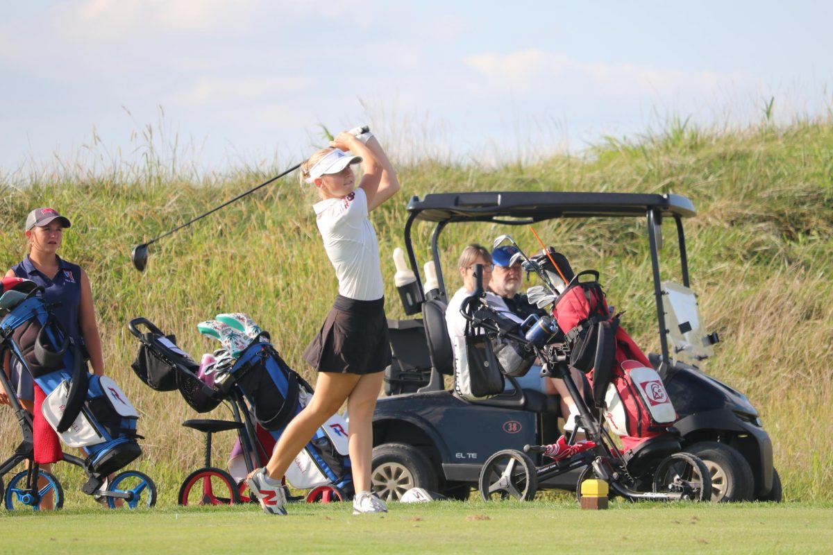 Sophomore Zoe Land finishes her drive on the eighth hole in a match against Roncalli. Land placed first individually for the first time in her varsity career and looks to bring that momentum into the Trojan Classic. “I have confidence that I can go into the Trojan Classic and put up a good number,” Land said. “I definitely think I can have a similar performance at the Trojan classic because I tend to play better when I play 18 because I can get in a groove and stick with it.”