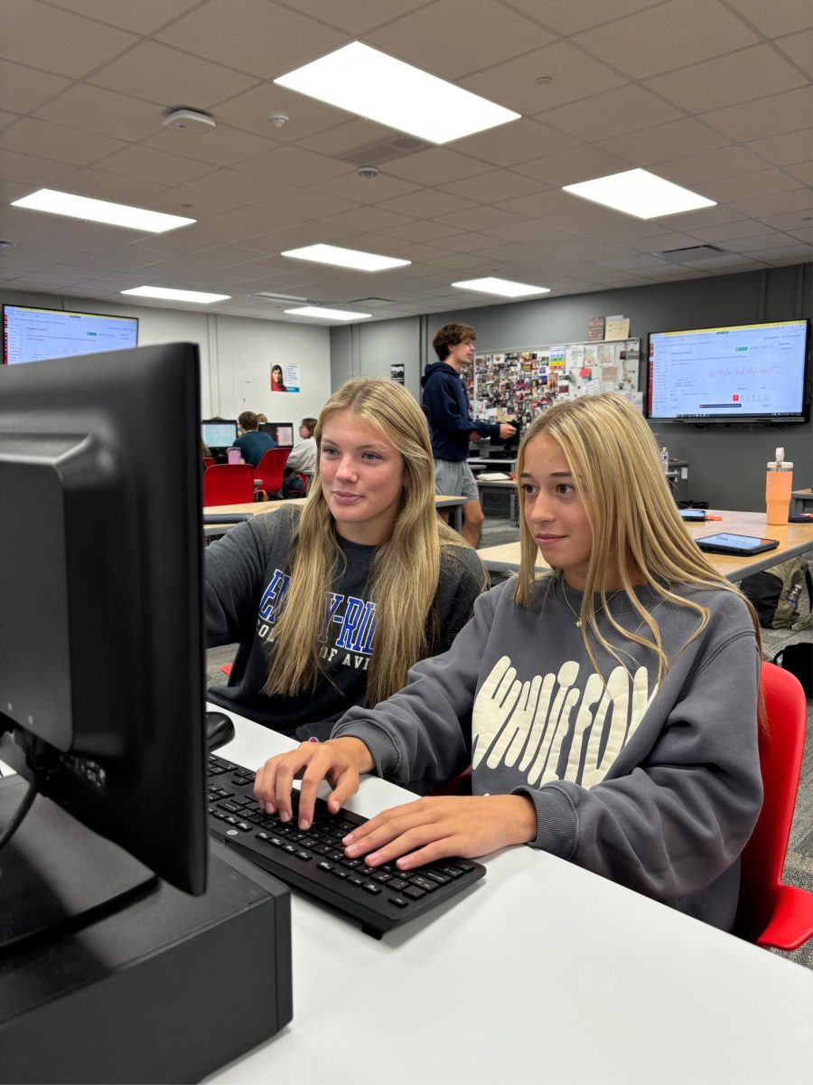 In Web Design class, seniors Hannah Vassar and Lyla Weir  work together to code an HTML website. After learning the basics of HTML in class, students are beginning to apply what they learned into making a website. “Right now we are just making basic websites with directions to follow,” Vassar said. “Then, in the future, we will have the basics perfected and be able to apply what we learned to more creative and complex projects.”