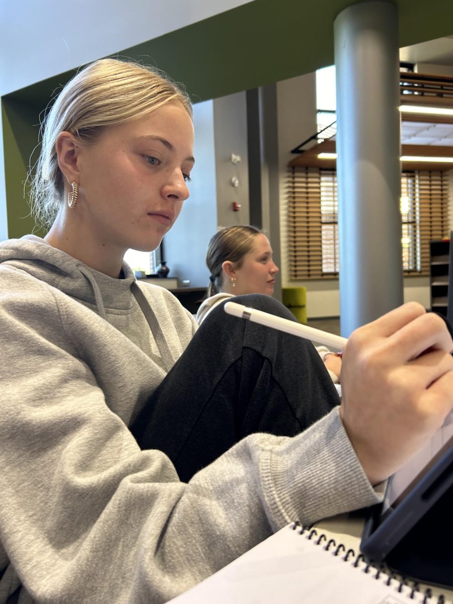 Junior Darbey Hause does homework in the media center during STaR. STaR is a class that has stayed constant in students' lives, allowing them to create bonds with their teachers and classmates. “I usually just do homework and talk with my friends in STaR. It’s helped me get closer with my STaR teacher and the people in my STaR class,” Hause said.