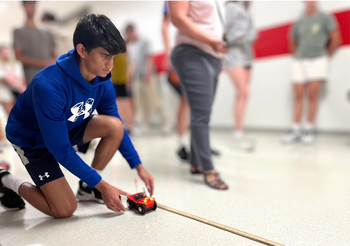 In Mrs. Elsner’s Honors Physics class, Aryan Nixon ‘27 prepares to release a toy car. As the students have been learning about rates of speed and velocity in class, they were asked to measure and compare the time it took for toy cars to travel a certain distance. “I liked it a lot,” Nixon said. “I enjoyed working together as a group and that I was controlling the car.”