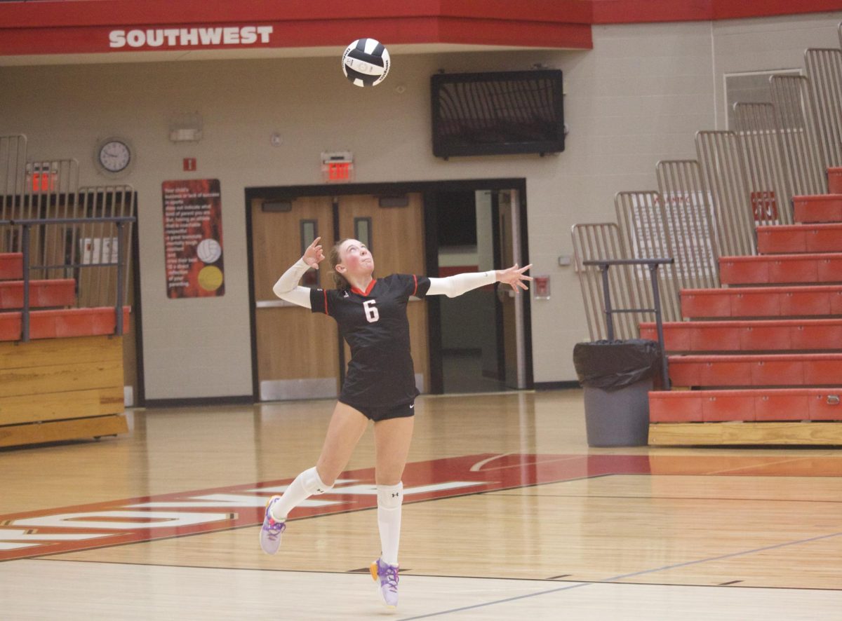 Alexis Dwyer ‘27 jumps to serve the ball during Monday’s home JV Volleyball match against Trinity Lutheran. The Trojans eventually lost the match in a third set to the Cougars, but Dwyer enjoyed her time behind the endline. “I enjoy starting the play and getting a good serve to make the other team out of the system, if possible,” Dwyer said.